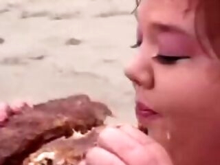 Immense lifeguard tarts eat food on the beach